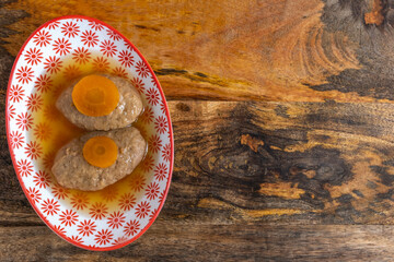 Gefilte fish for Jewish holiday Rosh Hashanah and Passover in beautiful bowl over wooden background with copy space.