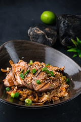 Rice with duck pieces, scrambled eggs, shiitake mushrooms and vegetables in a plate, closeup.