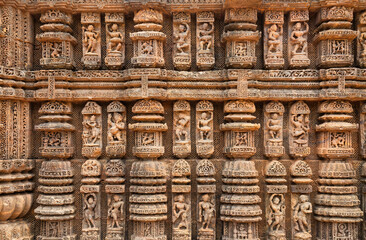 Konark sun temple wall with stone sculptures, carvings and artwork from the 13th century at Puri, Odisha, India