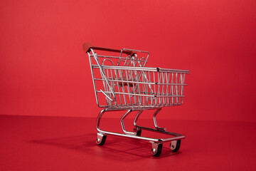 red empty shopping cart on red background