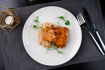Italian fresh Risotto with fried white fish served with green peas.