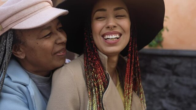 Happy African mother and daughter having a tender moment outdoor - Lovely family lifestyle concept