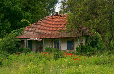 Old abandoned house in the countryside with broken roof and windows