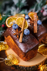 New Year's cake with delicate creamy dough and raisins decorated with spices, blueberries and dried orange slices
