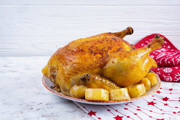 Roasted chicken and potato with Christmas decoration. Traditional food for Christmas or Thanksgiving day