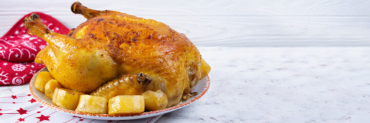 Roasted chicken and potato with Christmas decoration. Traditional food for Christmas or Thanksgiving day