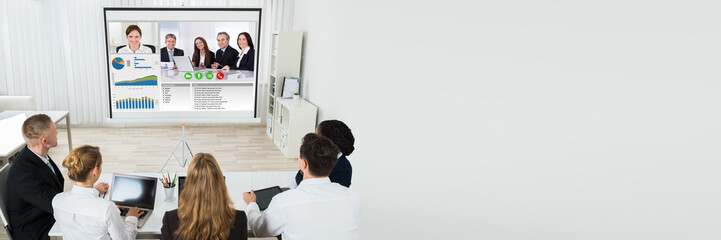 Businesspeople Discussing Graphs Through Videochat