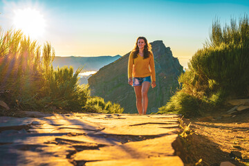 Sporty woman walking barefoot in the evening sun on Pico do Ariero on a super beautiful hiking...