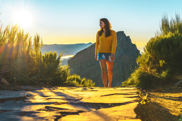 Sporty woman walking barefoot in the evening sun on Pico do Ariero on a super beautiful hiking...