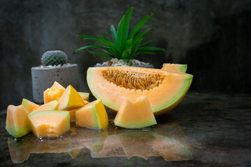 sliced of melons, fresh Melon or cantaloupCantaloupe melons on dark background, Favorite fruit in summer