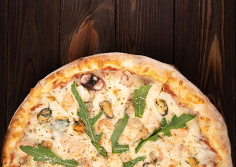 Seafood Pizza with Mozzarella, Various Seafood and Arugula.