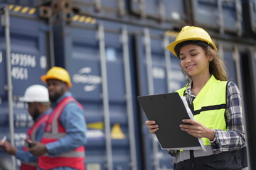 Caucasian engineer worman work in container port terminal. Female Industrial Engineer in Hard Hat, High-Visibility Vest Working. Inspector or Safety Supervisor in Container Terminal. logistics.