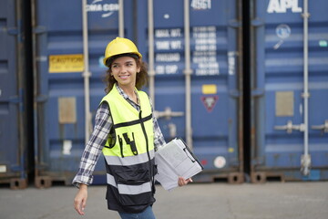Caucasian engineer worman work in container port terminal. Female Industrial Engineer in Hard Hat,...
