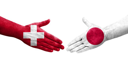 Fototapeta premium Handshake between Switzerland and Japan flags painted on hands, isolated transparent image.