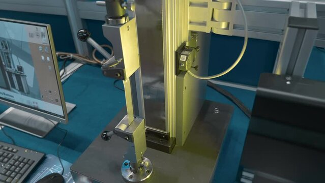 Tensile machine after testing the metal plate for breaking, give conclusions about the quality of the metal. Closeup. Shot in motion 