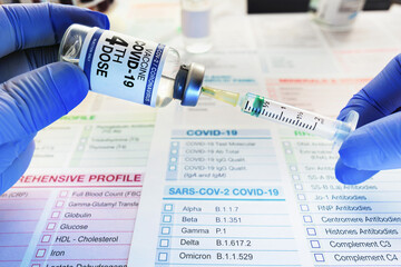 Syringe and vial of coronavirus vaccine labeled with the fourth dose on the label for vaccination...
