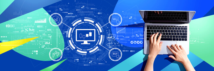 Stock trading theme with person using a laptop computer