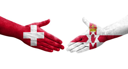 Handshake between Switzerland and Northern Ireland flags painted on hands, isolated transparent image.