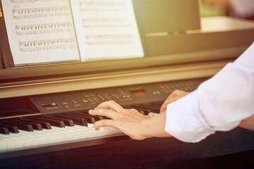 Woman plays electric piano at outdoor music performance, close up view to pianist nimble hands....