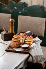 Breakfast fried potato pies, potato pancakes with meat, sausages, black pudding with sour cream and...