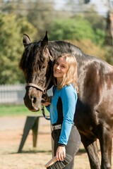 Obraz premium Vertical shot of a young female with a horse