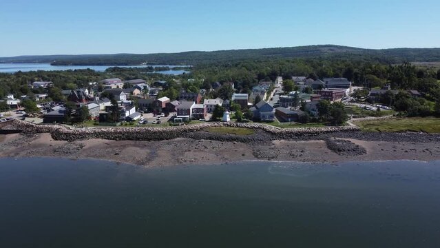 Aerial movement around Nova Scotia town surrounded by buildings and trees near Annapolis River