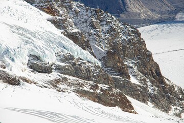 View of snow-covered rocky slopes in Jungfrau, Switzerland