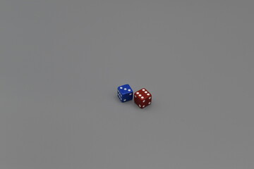 A red dice and a blue dice on a gray background