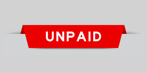 Red color inserted label with word unpaid on gray background