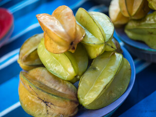 Star fruits  also known as Averrhoa Carambola on a plate for sale at the stall