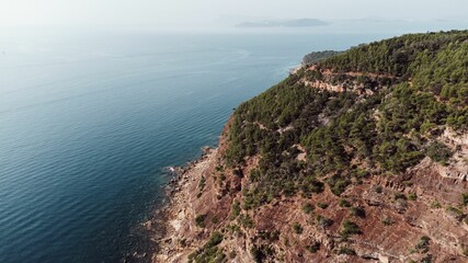 Aerial view of an island with green and overlooking blue ocean