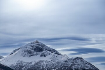 Winter mountains covered in snow above the floating clouds in Tresfjorden, Vestnes, Orskogfjellet