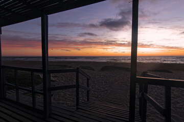 cabañas en la orilla del mar en la puesta de sol