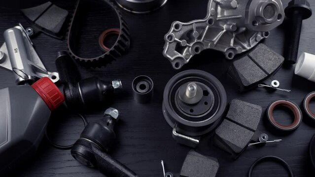 Auto parts spare parts car on grey background. Large number rotate on turntable around its axis. Auto parts store. Suspension and engine parts.