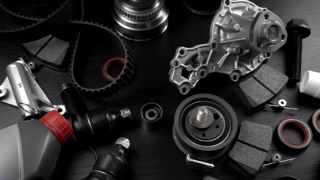 Auto parts spare parts car on grey background. Large number rotate on turntable around its axis. Auto parts store. Suspension and engine parts.