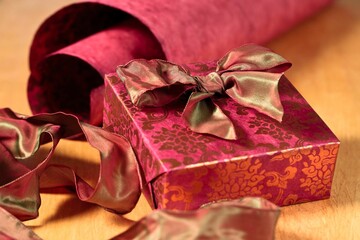 Wrapping a small red gift.