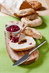 Bagel with jam on a wood plank