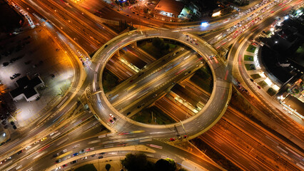 Aerial drone night photo of illuminated urban elevated toll ring road junction and interchange...