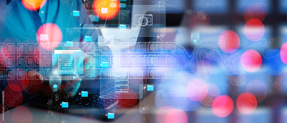 Poster ERP, document management concept.Businessman working with smart phone and laptop computer with icons on virtual screen and office blur background.