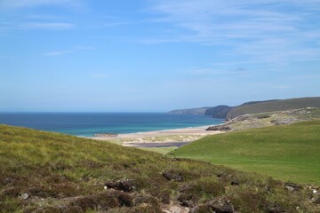Sunny day at the beach with a cloudy blue sky