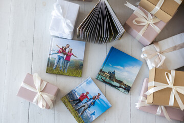a Photobook of family. Photobook is gift. photo album next to gifts.