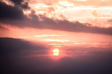 Sun descending on the horizon during a rainfall, Northern Italy