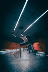 Dramatic vertical long exposure view of the people leaving the underground train station