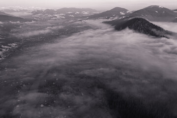 Panorama of a Ukrainian mountain village, a view of the village among the clouds from above.