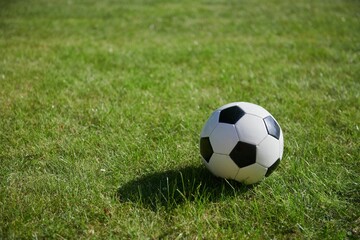 Fototapeta na wymiar Football ball in the green field