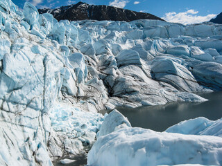 Matanuska Glacier terminus with seracs, crevasses, melted ice, and mountains