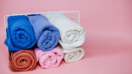 Obraz na płótnie Canvas multicolored terry towels in a white basket