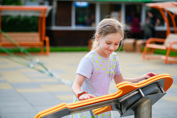 Little girl play interactive game at playground