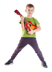 Cute boy playing the ukulele guitar isolated on white background - 545457477