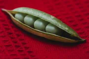 Closeup of peas in a pod on the table